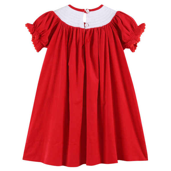 Back view of the red velvet Christmas bishop dress with two white buttons at the smocked neckline and gentle pleating down the length.
