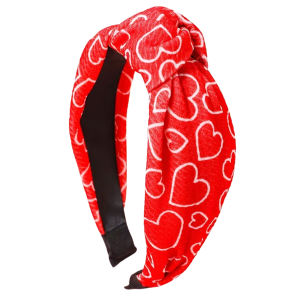 Red headband with white heart patterns on a white background