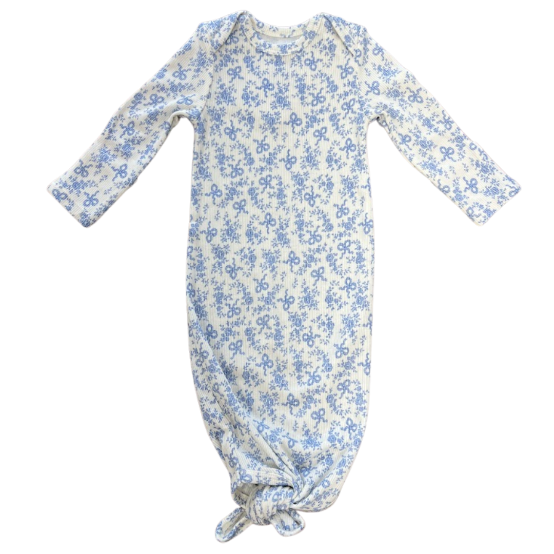blue floral and coquette bow print on a baby gown, knotted at the bottom with lap shoulder
