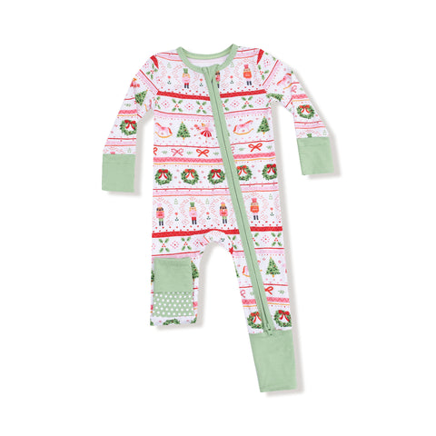 Holiday baby romper featuring pink Nutcracker Fair Isle print with mint green cuffs, patchwork legs, and diagonal zipper closure. 









