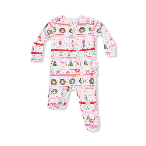 Baby girl ruffle footie pajamas in pink Nutcracker Fair Isle print with zipper front and ruffled bottom, holiday-themed bamboo sleepwear.

