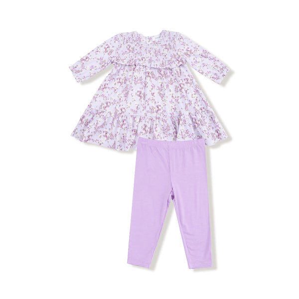 Two-piece set featuring a lavender floral smocked ruffle dress with tiered skirt and matching solid lilac leggings.

