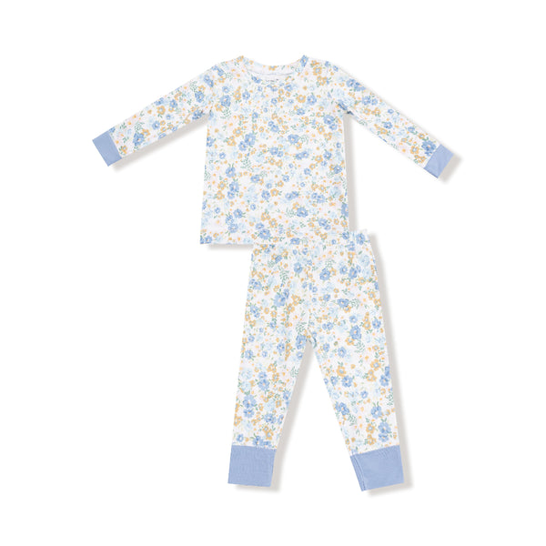 Two-piece kids' pajama set with blue and golden floral calico print, long sleeves, and blue cuff accents on top and pants.


