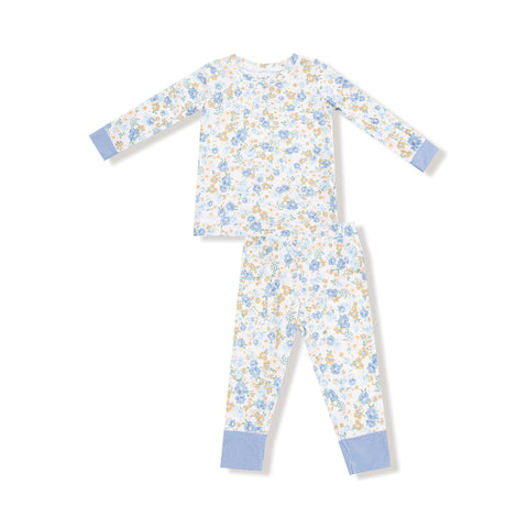 Two-piece kids' pajama set with blue and golden floral calico print, long sleeves, and blue cuff accents on top and pants.


