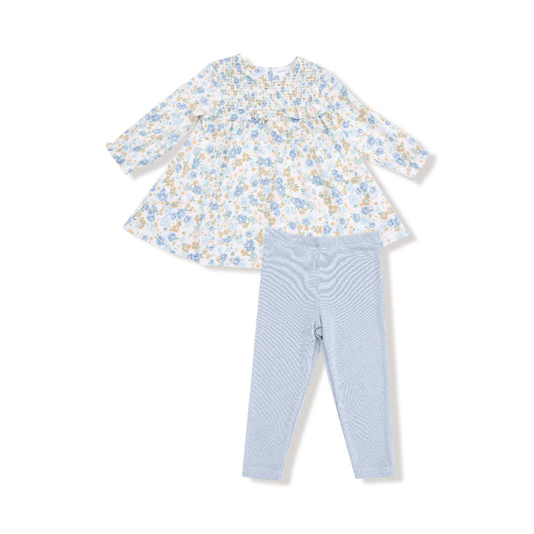 Two-piece girls’ outfit with a blue and golden floral smocked dress and matching light blue ribbed leggings.

