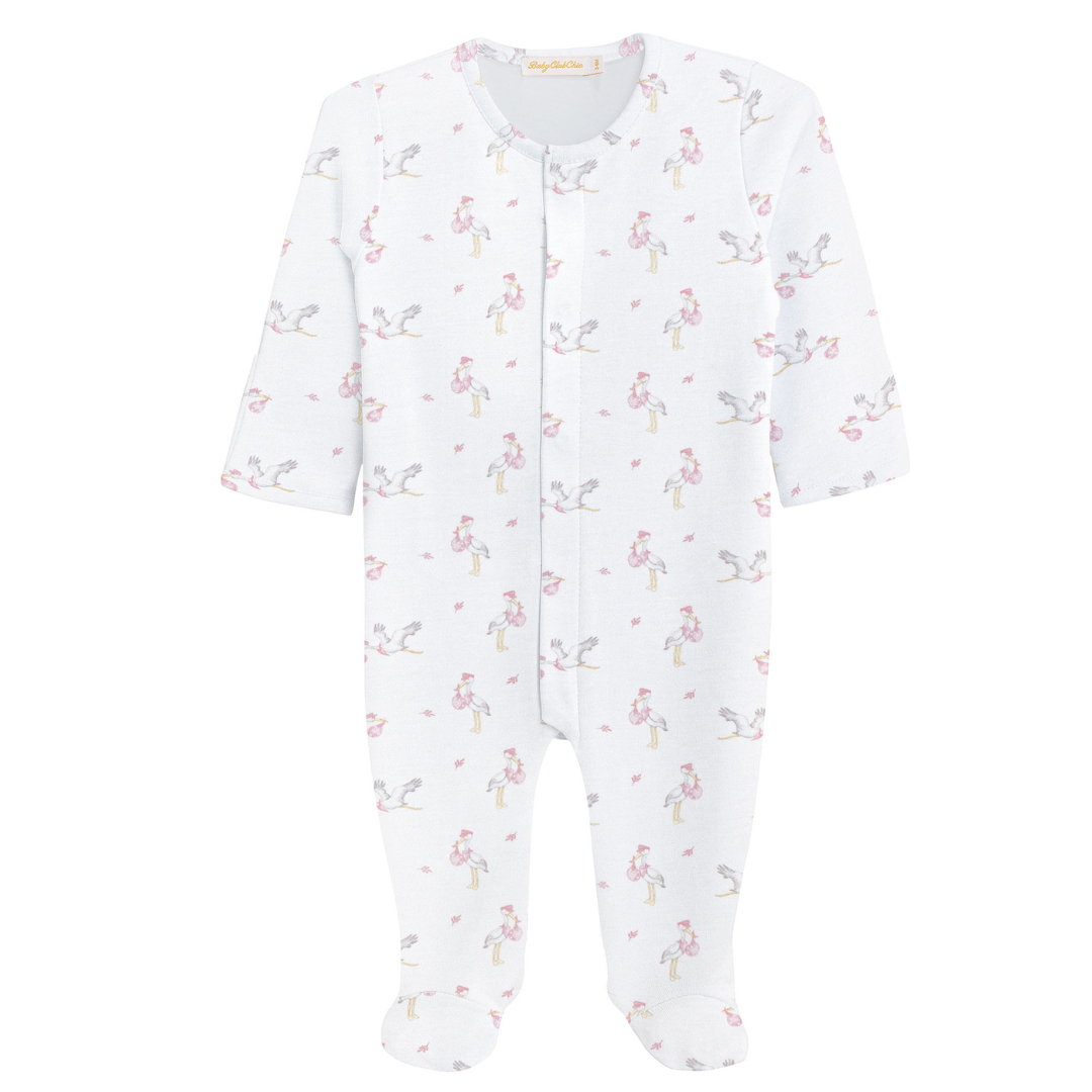 White baby footie with long sleeves, covered feet, and a pink stork print pattern carrying tiny pink bundles, featuring a snap-front closure.