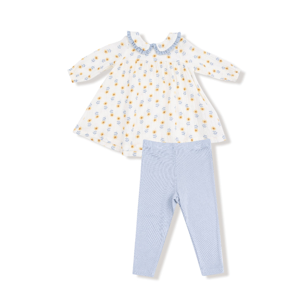 Two-piece girl's outfit with a white long sleeve dress in a yellow sunflower print and coordinating light blue ribbed leggings.

