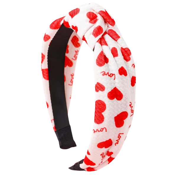 Headband with red heart patterns and 'love' text on a white background