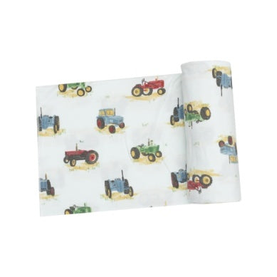 white swaddle blanket with tractors