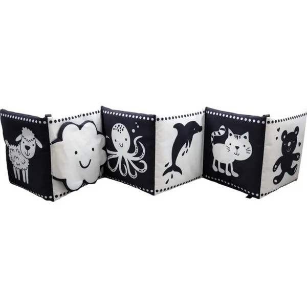 A black and white soft cloth baby book is shown in an accordion style, featuring a sheep, a cloud, an octopus, a dolphin, a cat, a bear, a flower with a mirror, an elephant, a monkey, a moon and stars, and an apple.