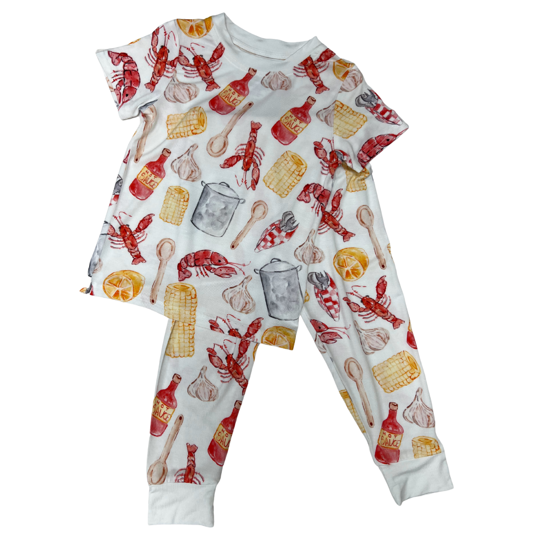 short sleeve and long pant bamboo pajama set with a watercolor print on white of crawfish, corn boiling pot and hot sauce print